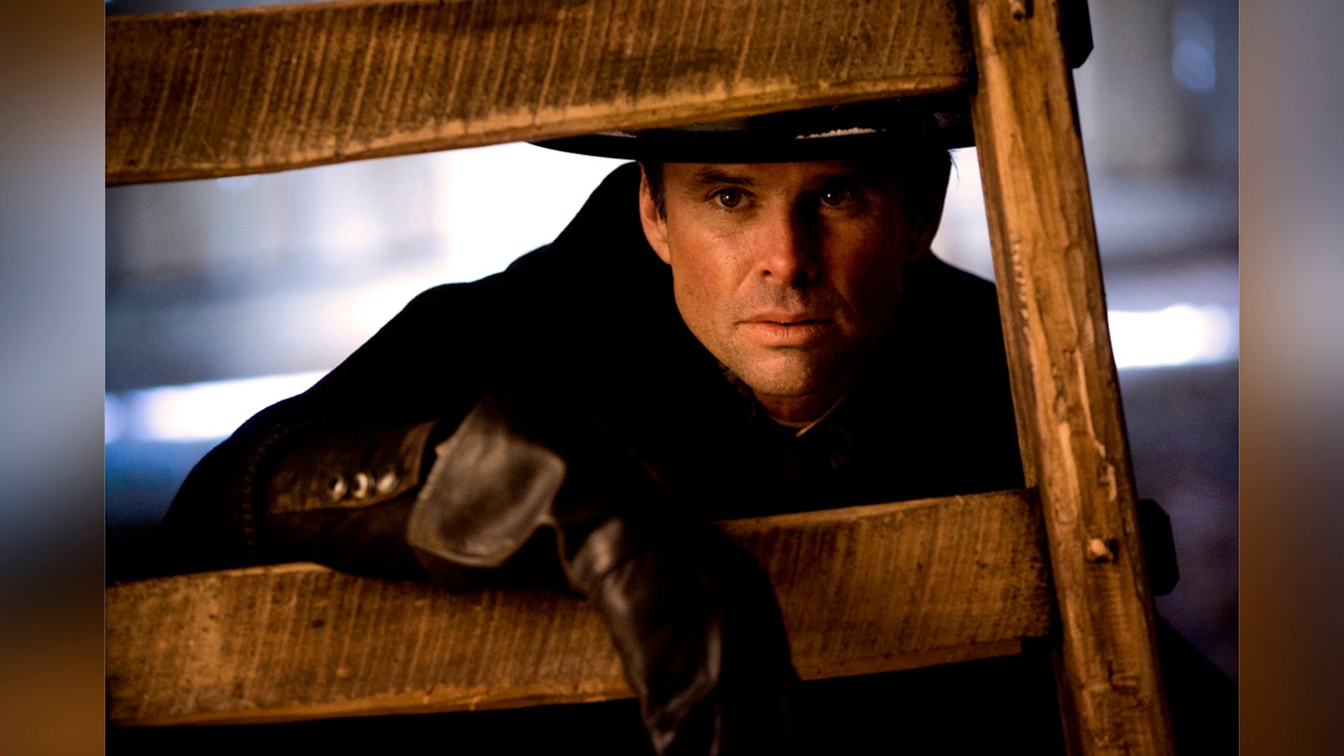 Walton Goggins peeks through the wooden staircase